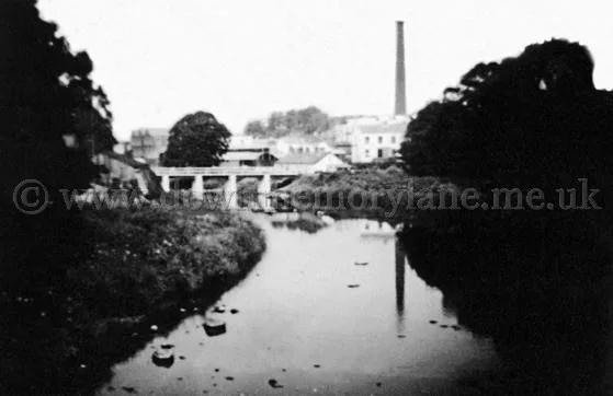 The Old Bleach chimney and factory outline beyond the River Maine