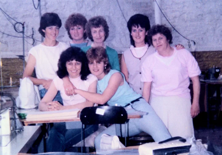 Seven women from the Old Bleach Stitching Room posing together in 1982